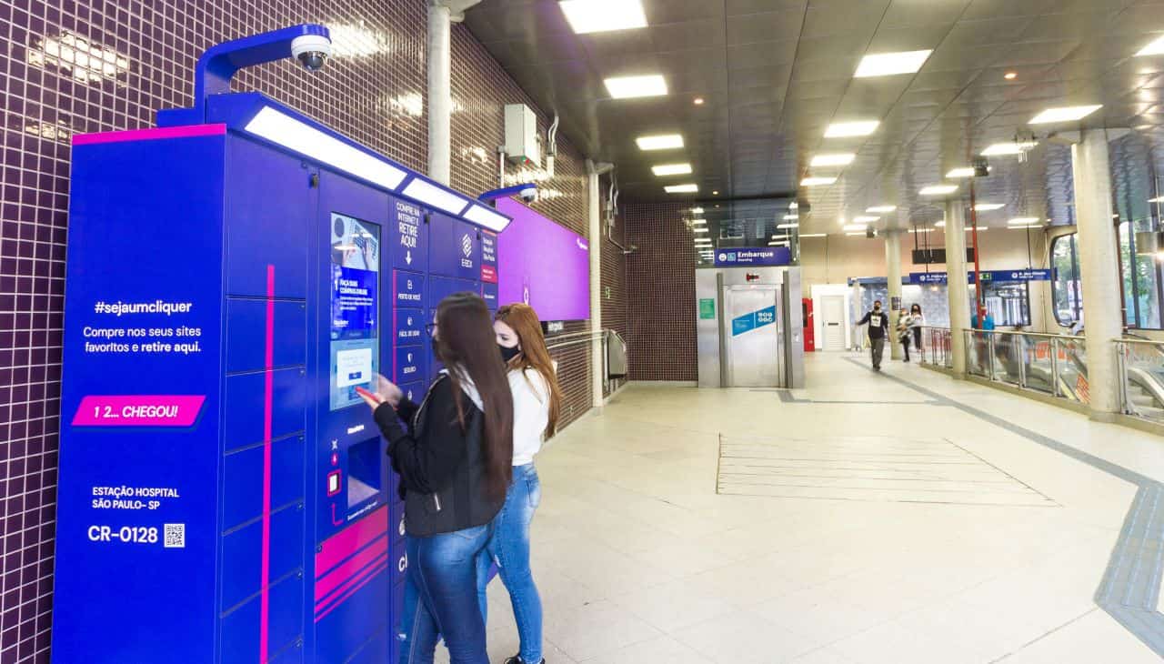 Imagem de duas garotas usando armários inteligentes em estação de metrô